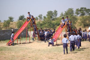 Dalit children playing on a slide